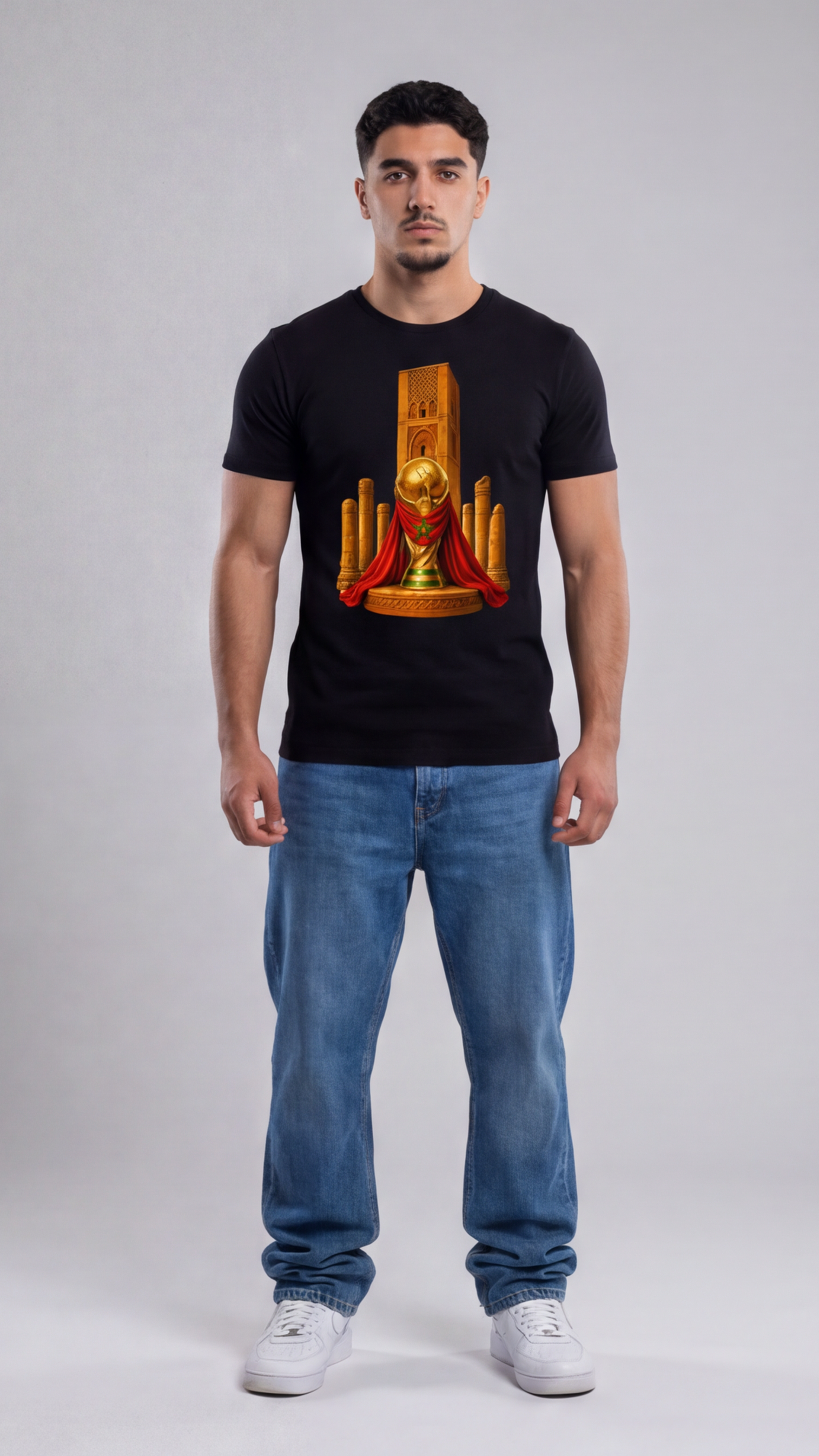 Man wearing a black t-shirt with a graphic design on a plain background