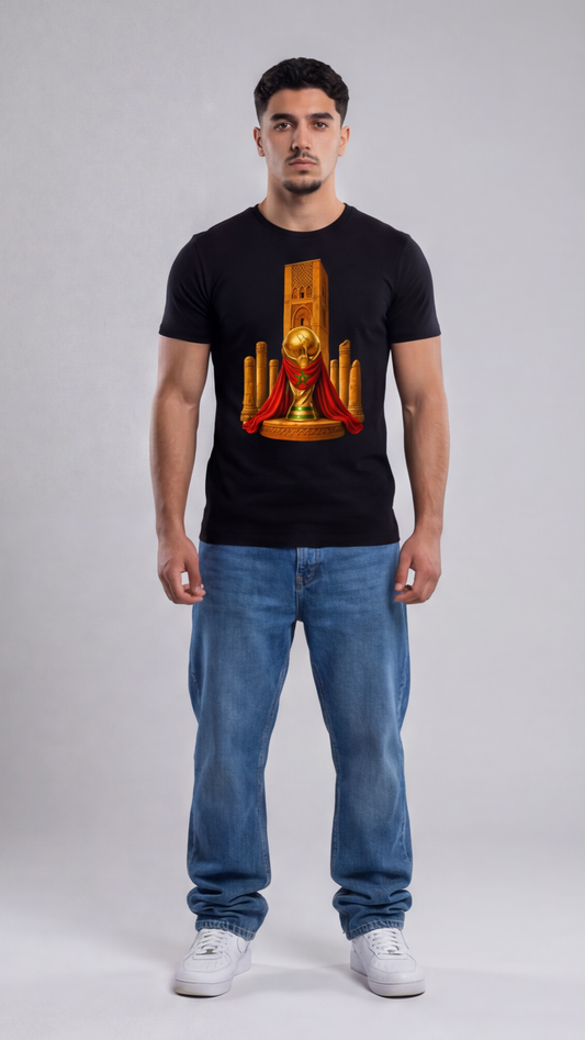Man wearing a black t-shirt with a graphic design on a plain background
